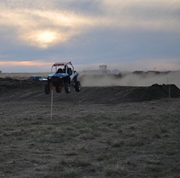 An ATV testing out a jump on the new Medicine Hat track. 