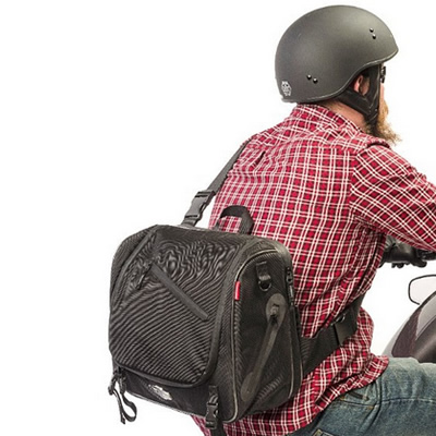 Picture of a rider wearing an Iron Rider Messenger Bag, made by Dowco. 