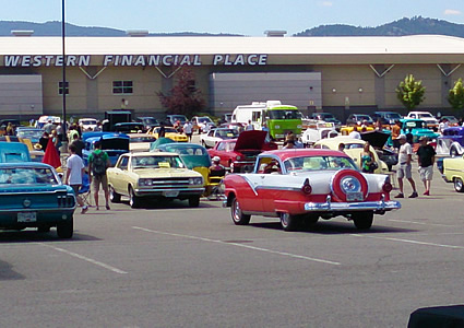 A bunch of classic cars parked at a car show. 