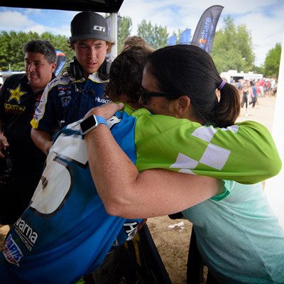 Tyler Medaglia's mom hugging him on the podium after a race. 