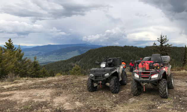 ATVs sit on top of a mountain