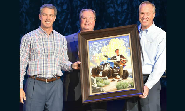 Three men making a boy scout presentation