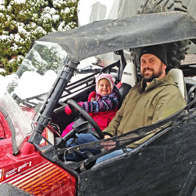 Chris Pylatuk sits in his UTV with his riding buddy, his five-year-old daughter, Lyla. 