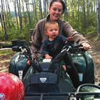 woman and young boy sitting on an ATV