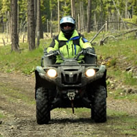 A man on a green ATV. 