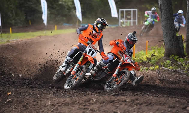 Kaven Benoit and Davi Millsaps are neck and neck as they round a corner on the mx track in New Brunswick. 