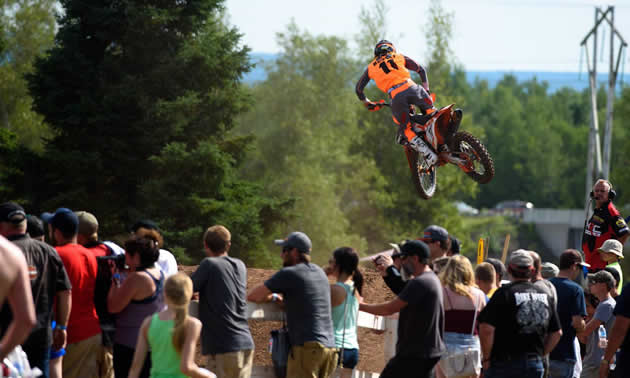 A crowd watches as Kaven Benoit whips it over a jump on the mx track in New Brunswick. 