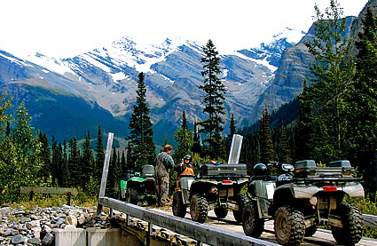 Photo of ATVers crossing a bridge