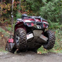 Popping a wheelie on an ATV. 