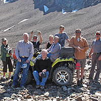 A group of ATVers standing at an old mine site. 