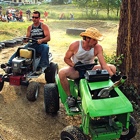 Guys racing lawn mowers