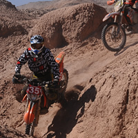 Two dirt bike riders going downhill at the ISDE. 