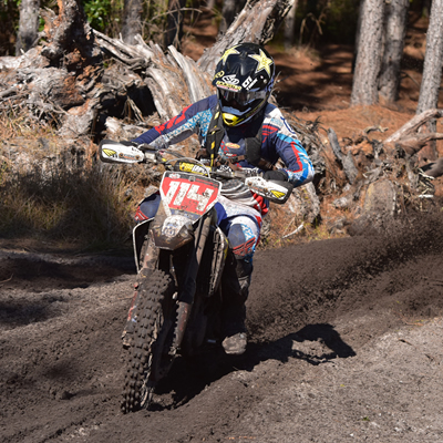 Josh Strang riding through a muddy section on the cross country race. 