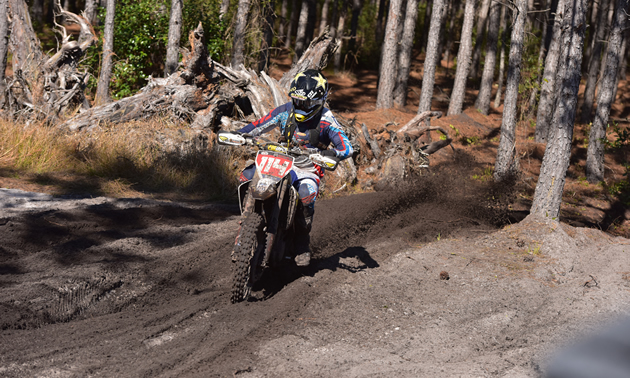 Josh Strang riding through a muddy section on the cross country race. 