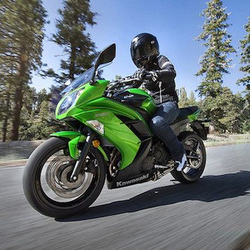 A Ninja 650 flying down a highway. 