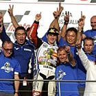 A group of people cheering on a podium. 