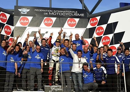 A group of people cheering on a podium. 