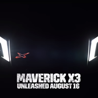 Screen capture of Maverick X3 trailer, showing headlights against black blackground, with words 'Maverick X3 - Unleashed August 16th'