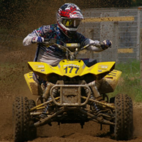 A man on a yellow race quad. 