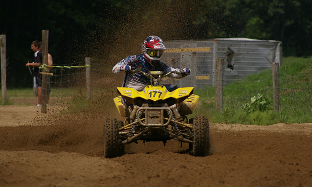 A man on a yellow race quad. 