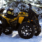 Photo of a tricked out yellow ATV. 