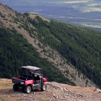 A side by side parked at the top of a mountain. 