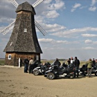 Spyder riders outside a windmill in Holland, Manitoba