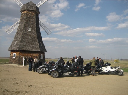 Spyder riders outside a windmill in Holland, Manitoba