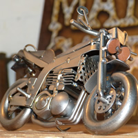 A metal motorcycle figuring with a man cave sign in the back. 