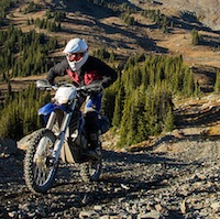 Steve Shannon riding up a rough mountain road.