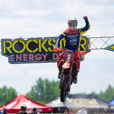 Cole Thompson fist pumps the air crossing the checkered flag. 