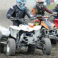 A group of ATVs racers on a dirt track. 