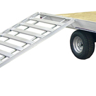 Photo of an ATV trailer with a ramp attached to the side of it. 