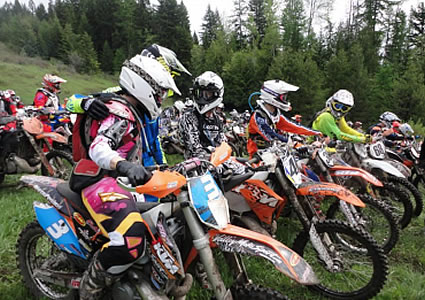 A group of racers at the starting line, talking to each other. 