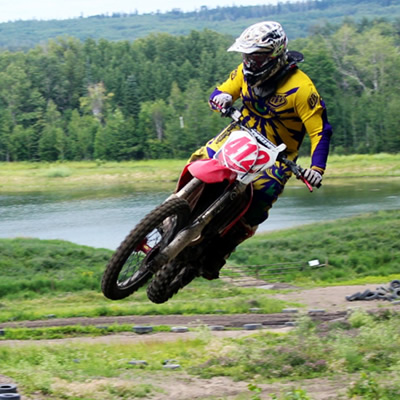 Man on a dirt bike sails over a jump in Whitecourt. 