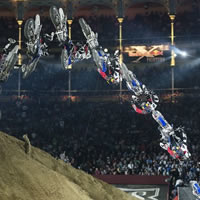 A freestyle motocross rider doing a trick at Red Bull X-Fighters. 