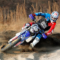 Yamaha enduro racer banking a corner.  